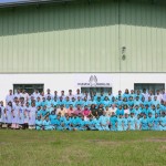 Here are all the Ezzy Sails workers lined up behind the main factory building.