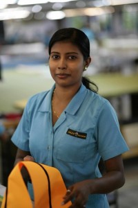 This is one of the smiling workers in the factory. In the photo she's working on a mast sleeve.